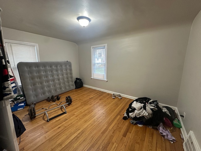 exercise area with light wood-type flooring