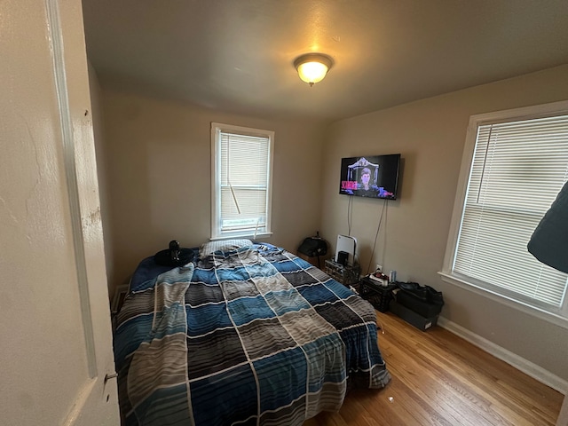 bedroom with wood-type flooring