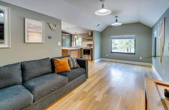 living room featuring light hardwood / wood-style flooring and lofted ceiling