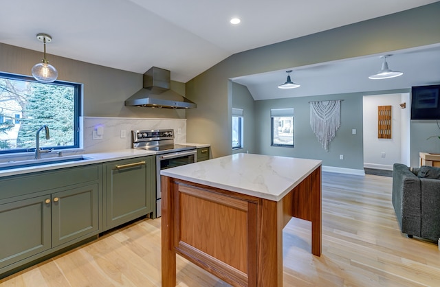 kitchen with sink, wall chimney exhaust hood, lofted ceiling, decorative light fixtures, and stainless steel range with electric cooktop