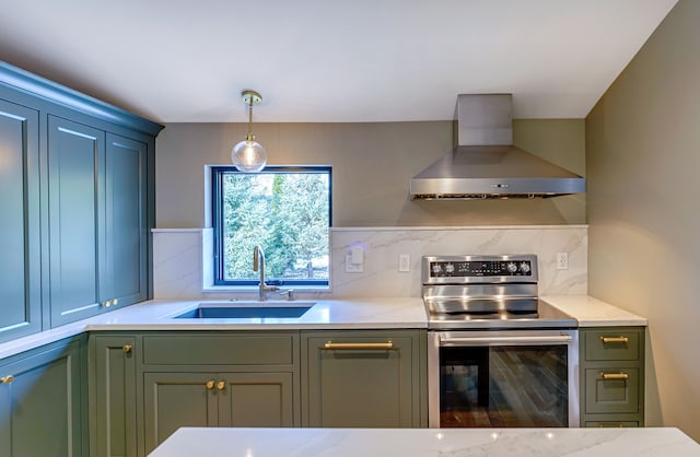 kitchen featuring sink, wall chimney range hood, pendant lighting, electric stove, and decorative backsplash