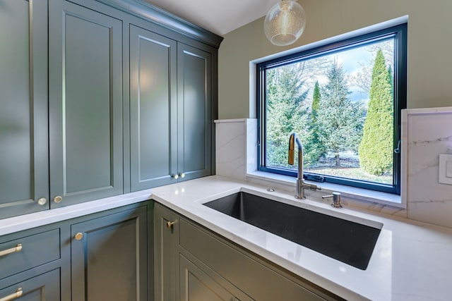 kitchen with decorative backsplash, plenty of natural light, and sink