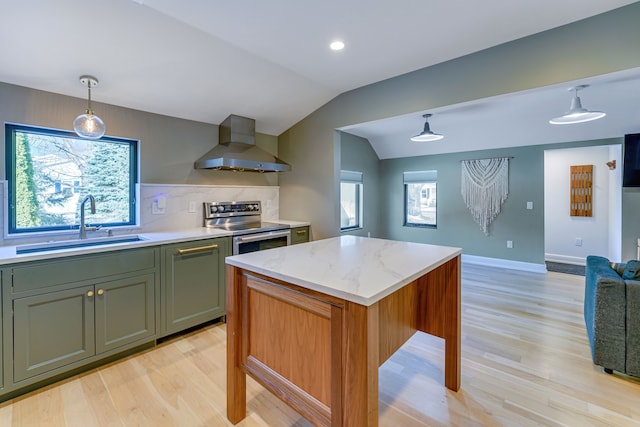 kitchen featuring stainless steel range with electric stovetop, wall chimney exhaust hood, vaulted ceiling, sink, and decorative light fixtures