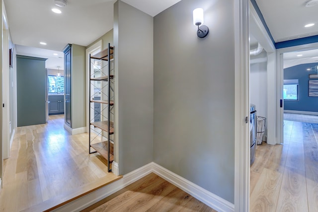 corridor with light hardwood / wood-style flooring