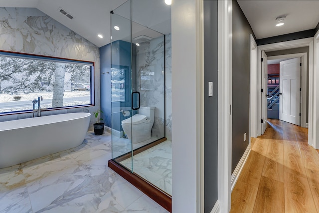 bathroom with vaulted ceiling, hardwood / wood-style flooring, toilet, and independent shower and bath