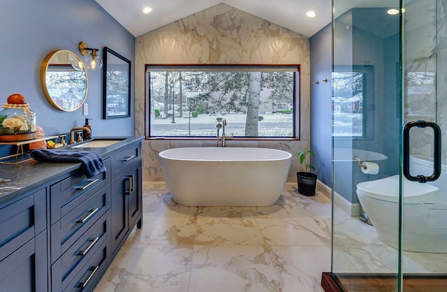 bathroom with tile walls, a washtub, vanity, and vaulted ceiling