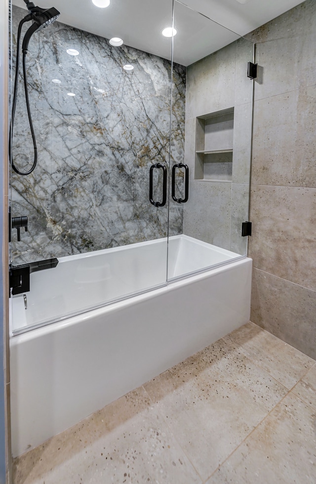 bathroom featuring shower / bath combination with glass door