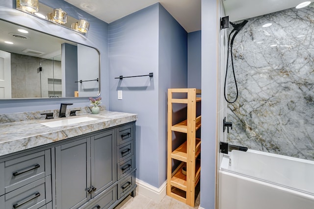 bathroom featuring tile patterned floors, vanity, and bath / shower combo with glass door