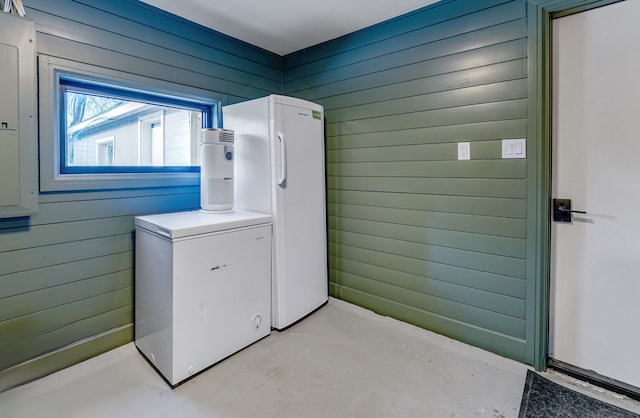 laundry area with wooden walls