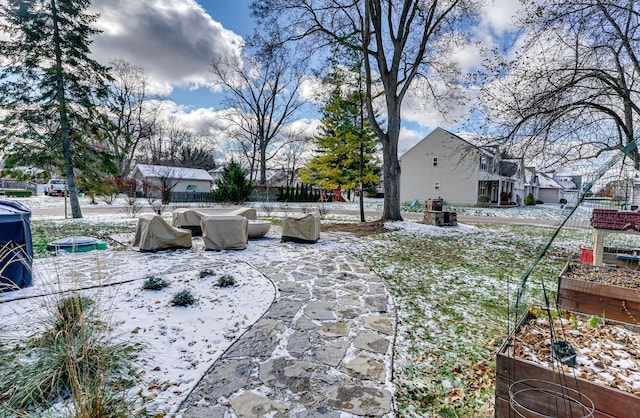 snowy yard with a patio area