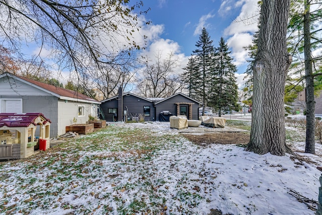 view of snow covered rear of property