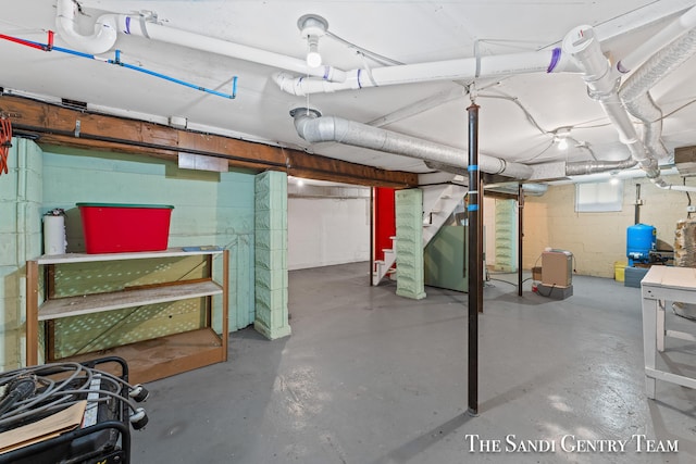 16248 Warner St, Grand Haven, MI 49417 - basement featuring stairs, a water pressure tank, and concrete block wall