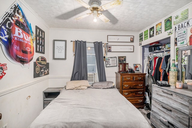 bedroom featuring a closet, ceiling fan, and crown molding