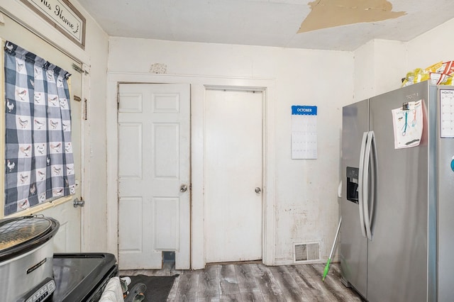 kitchen with hardwood / wood-style floors and stainless steel refrigerator with ice dispenser