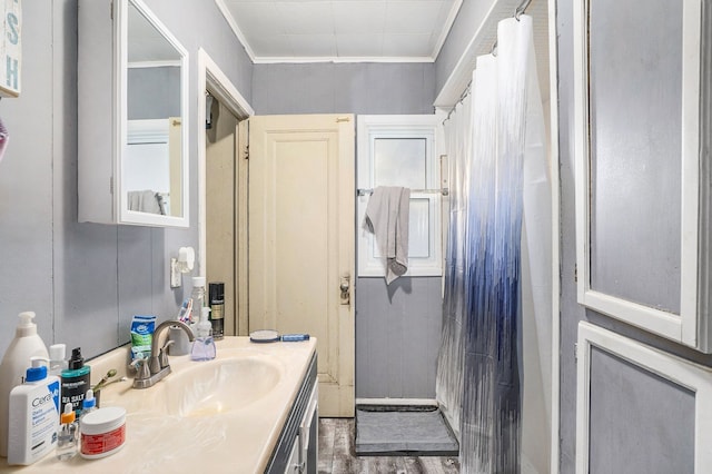 bathroom with wood-type flooring, vanity, a shower with curtain, and crown molding