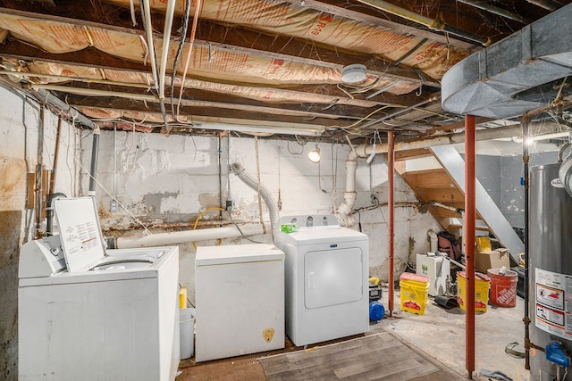 basement featuring washer and clothes dryer, gas water heater, and fridge