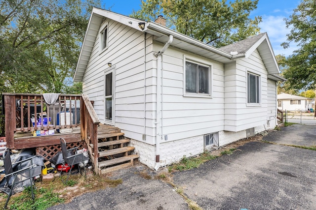 view of home's exterior featuring a wooden deck