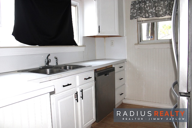 kitchen with white cabinets, appliances with stainless steel finishes, dark wood-type flooring, and sink