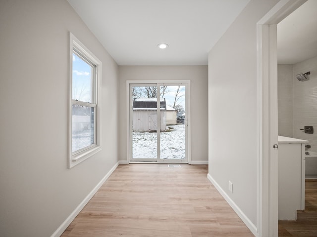 hall with light hardwood / wood-style floors