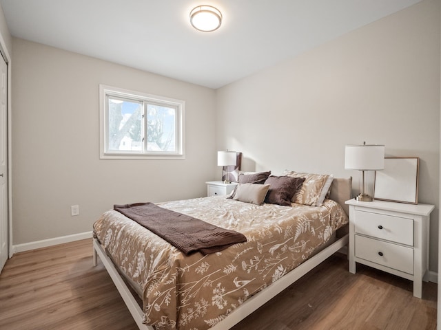 bedroom with dark hardwood / wood-style floors