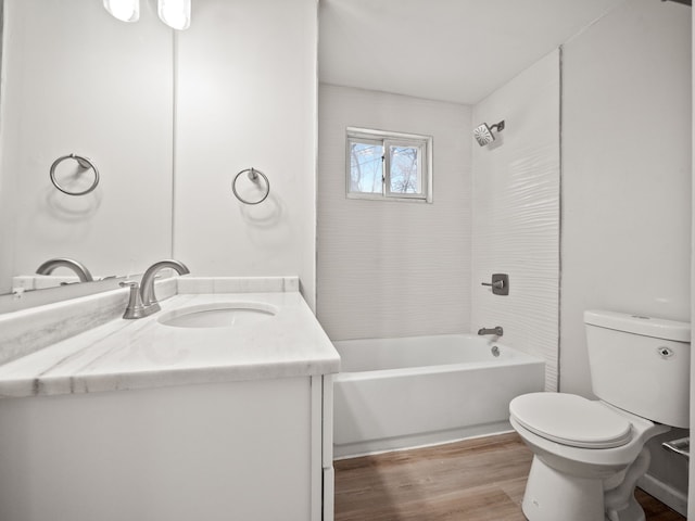 full bathroom featuring hardwood / wood-style floors, vanity, toilet, and tiled shower / bath combo