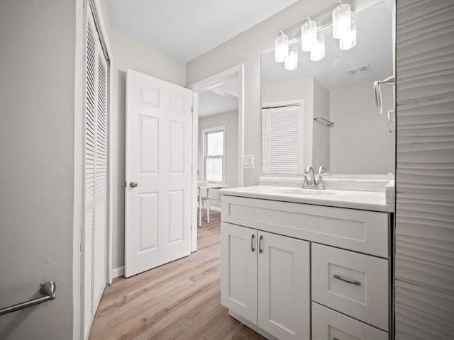 bathroom with vanity and hardwood / wood-style flooring