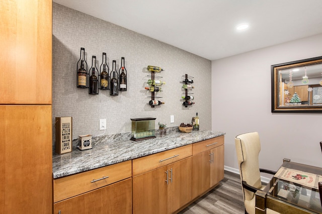 bar with baseboards and wood finished floors