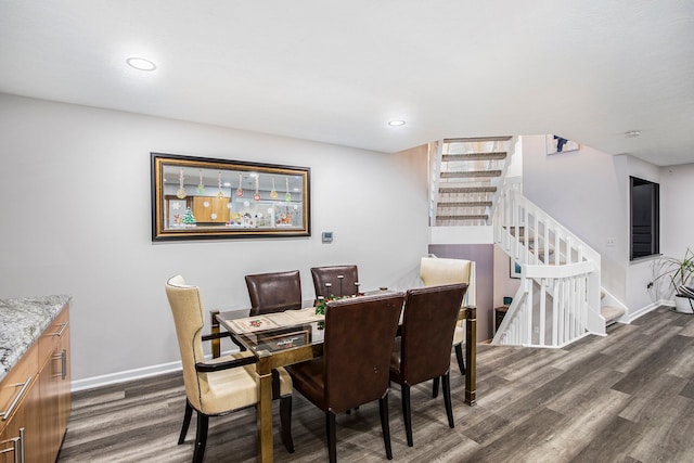 dining area featuring recessed lighting, baseboards, dark wood-type flooring, and stairs