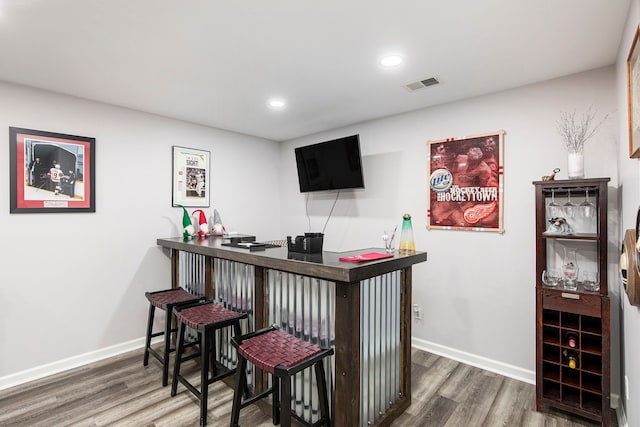 bar with dark hardwood / wood-style floors