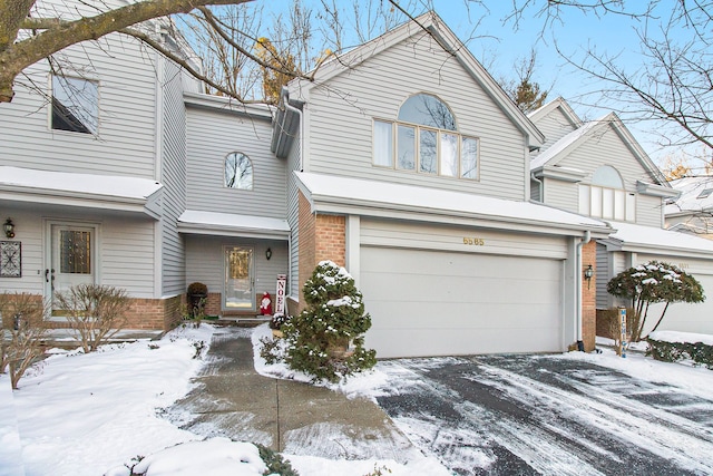 view of front of home with brick siding and a garage