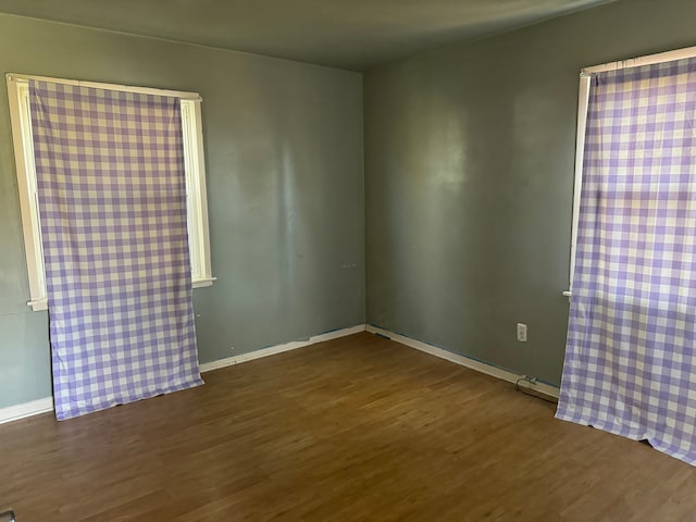 spare room with dark hardwood / wood-style flooring