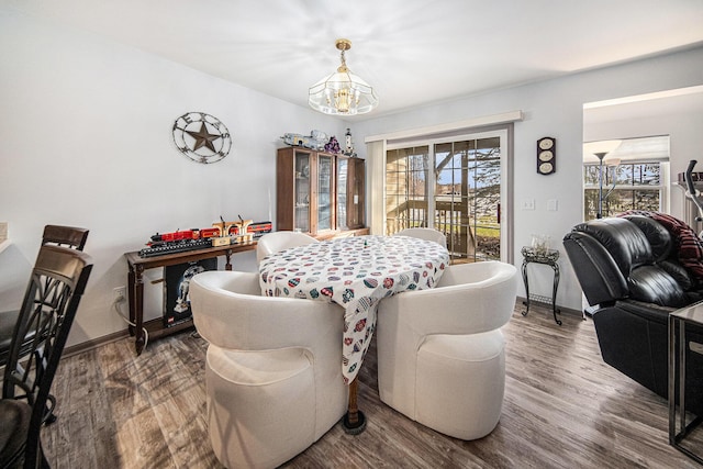 dining room featuring dark hardwood / wood-style flooring and a notable chandelier