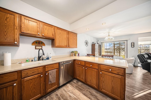 kitchen featuring dishwasher, kitchen peninsula, a wealth of natural light, and sink