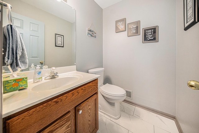 bathroom featuring vanity and toilet