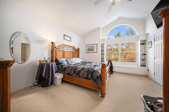 carpeted bedroom featuring multiple windows, lofted ceiling, and ceiling fan