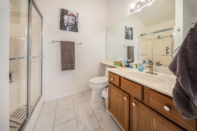 bathroom with vanity, toilet, and a shower with shower door