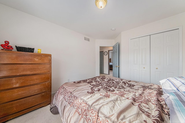 bedroom with light carpet and a closet