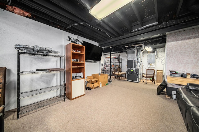 basement featuring heating unit, electric panel, and carpet floors