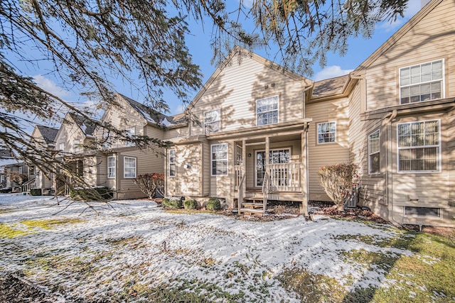 view of snow covered rear of property