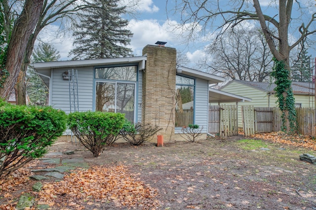 1930 Whittlesey St, Flint, MI 48503 - exterior space featuring fence and a chimney