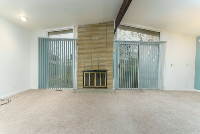 1930 Whittlesey St, Flint, MI 48503 - unfurnished living room with vaulted ceiling with beams, a fireplace, baseboards, and carpet flooring