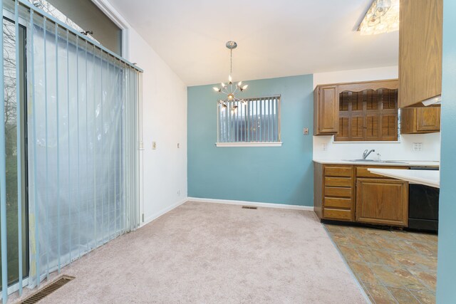1930 Whittlesey St, Flint, MI 48503 - kitchen featuring light countertops, a chandelier, brown cabinets, light carpet, and a sink