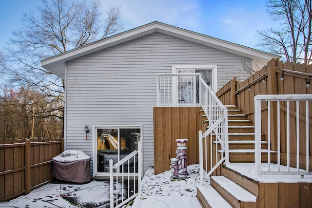 view of snow covered rear of property