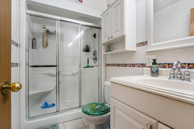 bathroom with tile patterned floors, walk in shower, vanity, a textured ceiling, and toilet