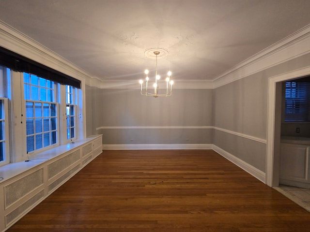 unfurnished dining area featuring dark hardwood / wood-style floors, ornamental molding, and an inviting chandelier