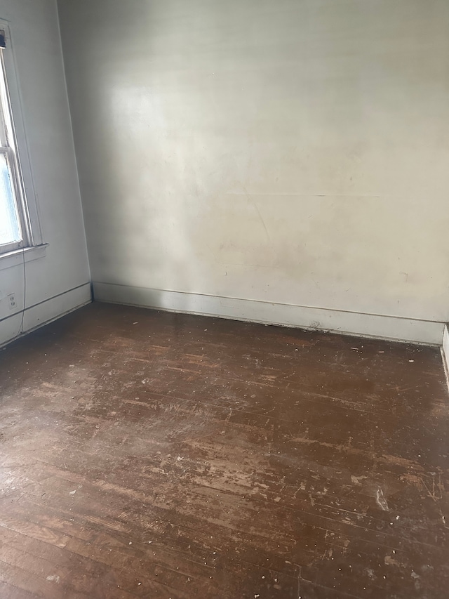 empty room featuring dark hardwood / wood-style flooring