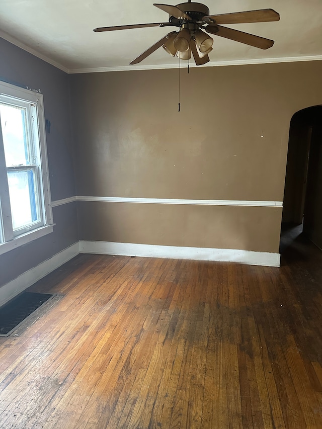 spare room with hardwood / wood-style flooring, ceiling fan, and ornamental molding