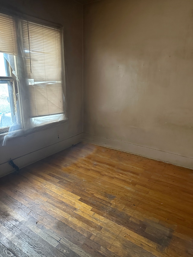 spare room featuring dark hardwood / wood-style flooring