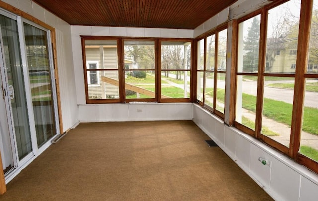 unfurnished sunroom with wood ceiling