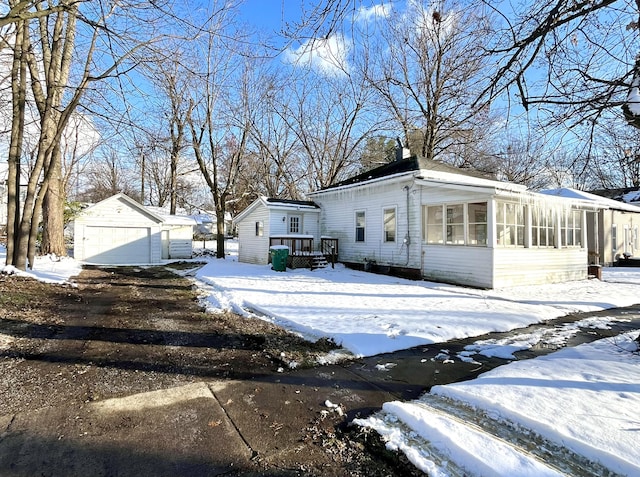 view of front of home with a garage and an outdoor structure